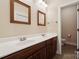 Bathroom with double sinks, wooden cabinets, and a tile floor at 369 Shoreline Pkwy, Tega Cay, SC 29708