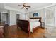 Bright primary bedroom features hardwood floors, tray ceiling, and ample natural light at 369 Shoreline Pkwy, Tega Cay, SC 29708