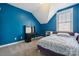Bedroom has a bright blue accent wall, carpeted floors, and a sloped ceiling at 369 Shoreline Pkwy, Tega Cay, SC 29708