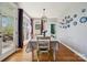 Bright dining room with hardwood floors, designer lighting, and large windows overlooking the deck at 369 Shoreline Pkwy, Tega Cay, SC 29708