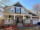 Charming home with stone accents, inviting front porch, and well-manicured landscaping at 369 Shoreline Pkwy, Tega Cay, SC 29708