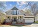 Charming two-story home with a inviting front porch and well-manicured landscaping at 369 Shoreline Pkwy, Tega Cay, SC 29708