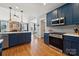 Updated kitchen with blue cabinets, stainless steel appliances and modern fixtures at 369 Shoreline Pkwy, Tega Cay, SC 29708