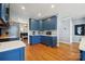 Bright kitchen with blue cabinets, stainless steel appliances and breakfast bar at 369 Shoreline Pkwy, Tega Cay, SC 29708