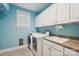 Well-equipped laundry room with modern appliances, ample storage, and a utility sink at 369 Shoreline Pkwy, Tega Cay, SC 29708