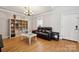 Cozy living room with hardwood floors, large shelving unit and neutral paint at 369 Shoreline Pkwy, Tega Cay, SC 29708