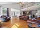 Bright, open living space with hardwood floors seamlessly flowing into kitchen and dining area at 369 Shoreline Pkwy, Tega Cay, SC 29708