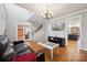 Open-concept living area with hardwood floors, staircase, and view into kitchen at 369 Shoreline Pkwy, Tega Cay, SC 29708