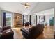 Spacious living room featuring a stone fireplace and hardwood floors with high ceilings at 369 Shoreline Pkwy, Tega Cay, SC 29708