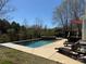 Beautiful in-ground pool with lounge chairs and natural surroundings at 369 Shoreline Pkwy, Tega Cay, SC 29708
