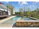 Backyard pool and spa with stone accents and a natural view, perfect for relaxation at 369 Shoreline Pkwy, Tega Cay, SC 29708