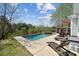 Backyard pool and patio area with a hot tub and lush landscaping at 369 Shoreline Pkwy, Tega Cay, SC 29708