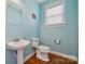Stylish powder room featuring attractive fixtures and finishes and bright blue walls at 369 Shoreline Pkwy, Tega Cay, SC 29708