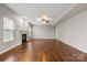 Spacious living room with hardwood floors, fireplace, ceiling fan, and natural light at 4095 Harmattan Dr, Denver, NC 28037