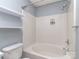 Well lit bathroom featuring a shower-tub combo with tiled walls and a sleek shower head with extra shelving at 4677 Arthur Way, Rock Hill, SC 29732
