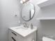 Stylish bathroom featuring a modern vanity, sink, round mirror, and sleek fixtures with extra shelving at 4677 Arthur Way, Rock Hill, SC 29732