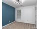 Inviting bedroom featuring large window and a modern light fixture against a two-toned wall at 4677 Arthur Way, Rock Hill, SC 29732
