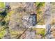 An aerial view captures the home's roof, driveway and yard, nestled amidst mature trees and greenery at 5009 Milford Rd, Charlotte, NC 28210