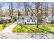Charming renovated home with a manicured front lawn and mature shade trees at 5009 Milford Rd, Charlotte, NC 28210