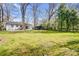 Expansive backyard featuring lawn, mature trees and storage shed at 5009 Milford Rd, Charlotte, NC 28210