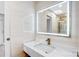 Beautiful modern bathroom featuring sleek marble vanity, elegant faucet, and large, illuminated mirror at 5009 Milford Rd, Charlotte, NC 28210