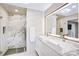 Bright bathroom showcasing a glass-enclosed shower, dual sinks, and a large, illuminated mirror at 5009 Milford Rd, Charlotte, NC 28210