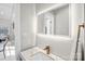 Modern powder room with illuminated mirror, marble countertop, and sleek faucet at 5009 Milford Rd, Charlotte, NC 28210