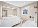 Bright bathroom with double sinks, large mirror, and a modern tub at 5009 Milford Rd, Charlotte, NC 28210