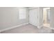 Bright bedroom featuring fresh paint, new floors, closet, and an ensuite bathroom at 5009 Milford Rd, Charlotte, NC 28210