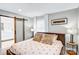 Cozy bedroom with a large bed, soft lighting, and barn door access to bathroom at 5009 Milford Rd, Charlotte, NC 28210