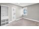 Neutral bedroom with plenty of natural light, updated flooring, and closet with built-ins at 5009 Milford Rd, Charlotte, NC 28210