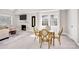 Elegant dining area with stylish chairs, marble fireplace and view of the living room at 5009 Milford Rd, Charlotte, NC 28210