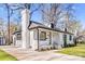 Beautifully renovated white brick home with black trim and a well maintained lawn at 5009 Milford Rd, Charlotte, NC 28210