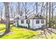 Well-maintained white brick home with black shutters and lush green lawn at 5009 Milford Rd, Charlotte, NC 28210