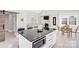 Modern kitchen with black countertop island and view of the living and dining areas at 5009 Milford Rd, Charlotte, NC 28210