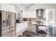 Modern kitchen with stainless steel appliances, white cabinetry, and a black marble island at 5009 Milford Rd, Charlotte, NC 28210