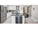 Gourmet kitchen with stainless steel appliances, island seating, and wine refrigerator at 5009 Milford Rd, Charlotte, NC 28210