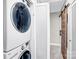 Convenient laundry room with stacked washer and dryer, door, and modern fixtures at 5009 Milford Rd, Charlotte, NC 28210
