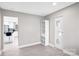 Open living room space with views to the kitchen and featuring new floors and modern built-ins at 5009 Milford Rd, Charlotte, NC 28210