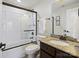 Well-lit bathroom featuring a granite countertop, framed shower, and modern fixtures, providing a luxurious feel at 5059 Saint Clair St, Fort Mill, SC 29715