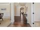 Spacious foyer showcasing hardwood floors, elegant trim, and arched doorways to other living spaces at 5059 Saint Clair St, Fort Mill, SC 29715