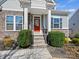 Close-up of the home's entrance, showcasing the welcoming red door and landscaped stairs at 5059 Saint Clair St, Fort Mill, SC 29715