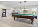 Spacious game room features a pool table with elegant lighting, ideal for entertaining and relaxation at 5059 Saint Clair St, Fort Mill, SC 29715