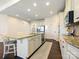 Well-lit kitchen featuring a center island with seating, stainless steel appliances, and ample cabinet space at 5059 Saint Clair St, Fort Mill, SC 29715