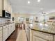 Bright, spacious kitchen with granite countertops and stainless steel appliances open to the dining and living area at 5059 Saint Clair St, Fort Mill, SC 29715