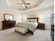 Tranquil primary bedroom with trey ceilings, a spacious layout, and dark wood furnishings at 5059 Saint Clair St, Fort Mill, SC 29715