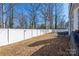 Spacious backyard with a white fence and a seating area perfect for outdoor gatherings at 5616 Ebley Ln, Charlotte, NC 28227
