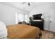 Bright bedroom features a fan, vaulted ceiling, a desk, natural light, and a large television at 5616 Ebley Ln, Charlotte, NC 28227
