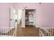 Bright bedroom features a closet, hardwood floors, and pink-painted walls for a playful atmosphere at 5616 Ebley Ln, Charlotte, NC 28227
