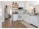 Bright kitchen features white cabinets, farmhouse sink, floating shelves, and stainless steel appliances at 5616 Ebley Ln, Charlotte, NC 28227